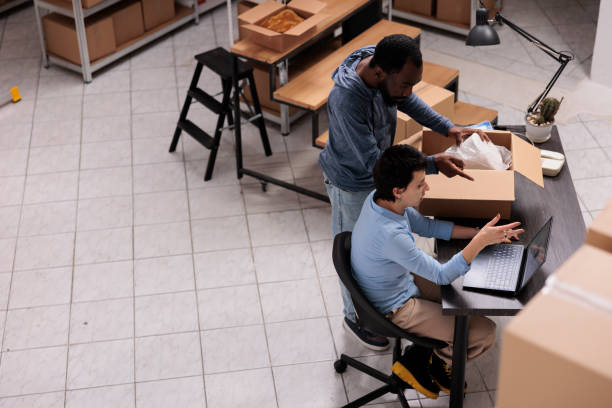 istock Top view of team discussing about transportation logistics while looking at cargo stock on laptop computer 1442142700