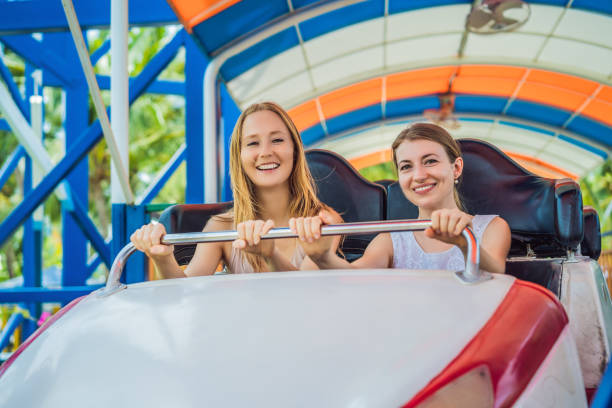istock Happy friends in amusement park on a summer day 1442143353
