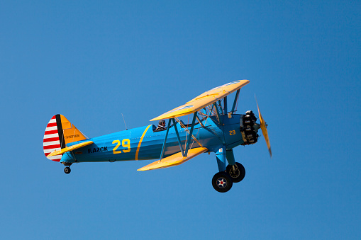 World War II trainer aircraft in original 1940s US Army paint scheme. Stearman PT-17 Kaydet.