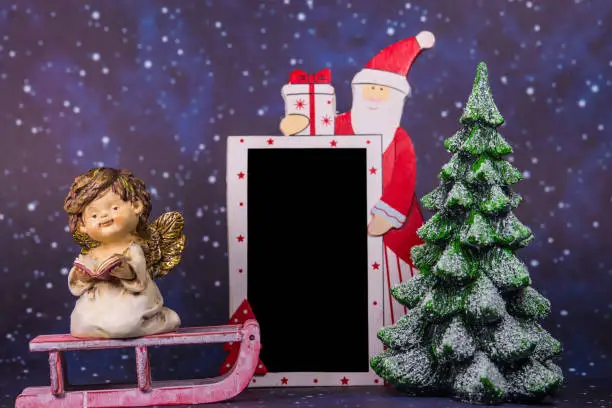 Photo of Santa Claus with empty blackboard