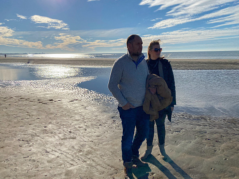 Couple having a beach walk on sunny November day