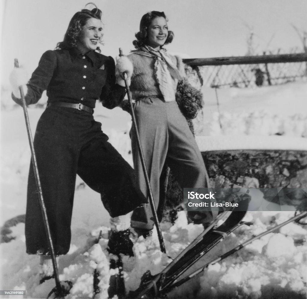Young Women skiing in the mountains. 1935. Young Women enjoying skiing together in the mountains. Winter Holidays on European Alps, 1935. Retro Style Stock Photo