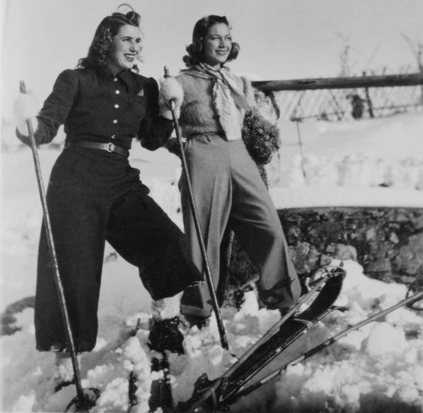 young women skiing in the mountains. 1935. - skiing winter women snow imagens e fotografias de stock