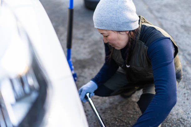 istock Female changing regular tires to winter studless tires 1442150309
