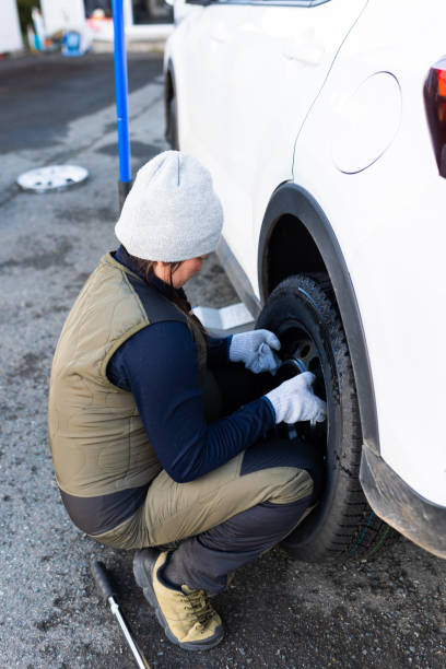 istock Female changing regular tires to winter studless tires 1442150355