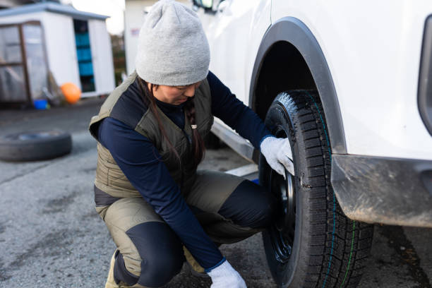 istock Female changing regular tires to winter studless tires 1442150366