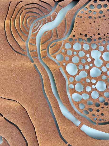 Vertical full frame of thin rusted sheet metal cut out into abstract art design pattern on community public wall in park Byron Bay Australia