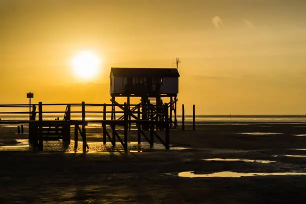 Silhouette stilt houses of Sankt Peter-Ording on the North Sea beach