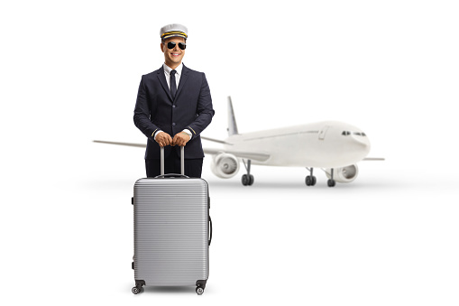 Parked aiprlane and a pilot standing with a suitcase isolated on white background