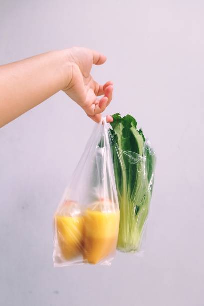 istock Woman Holding Plastic Bag with Juice and Vegetables 1442156084