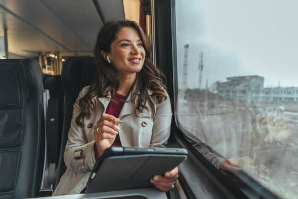 istock Young businesswoman using a digital tablet while working in the train. 1442157503