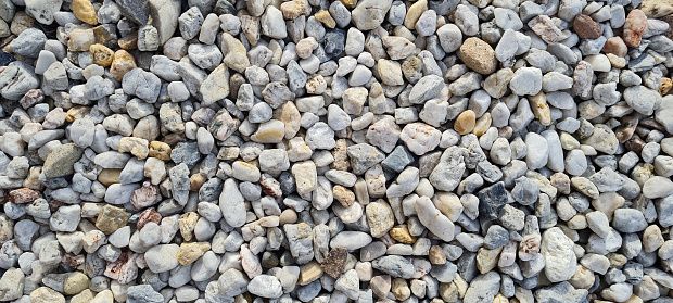 Natural gravel texture. Multi colored pebbles. Beautiful background. Vacation, holiday, beach mood