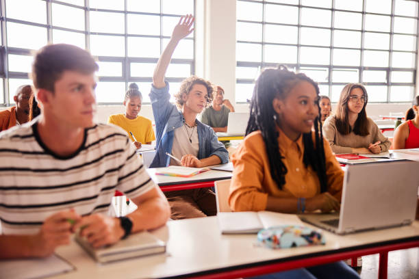 istock Student raising his hand to ask a question in a classroom 1442158310