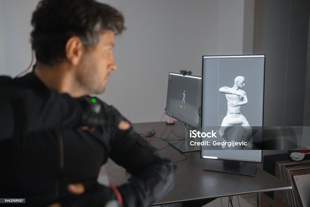 A Caucasian Guy Is Creating A 3d Animation By Using A Mockup Smart Suit Stock Photo - Download Image Now - iStock A Caucasian Guy Is Creating A 3d Animation By Using A Mockup Smart Suit Stock Photo - Download Image Now - iStock