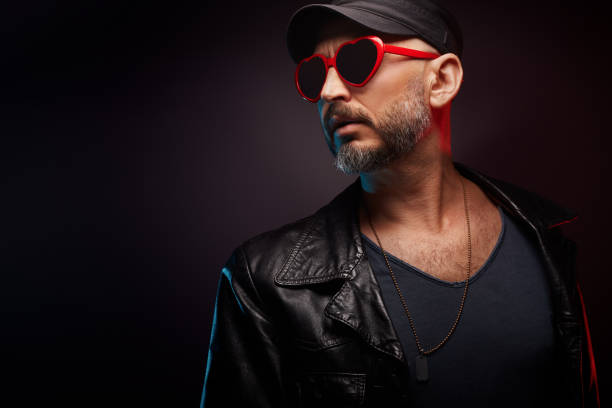 istock Stylish handsome man wearing leather jacket with heart shaped red sunglasses 1442159169
