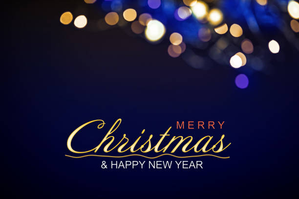 Christmas background in blue tones with defocused Christmas lights and space for copy. Merry Christmas and Happy new year text.