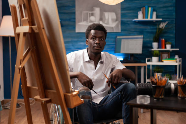 istock African american wheelchair user working at art studio 1442161886