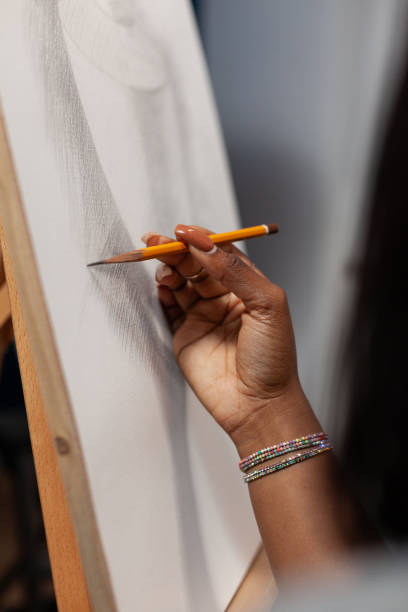 istock Closeup of art student hand holding graphics pencil 1442164521