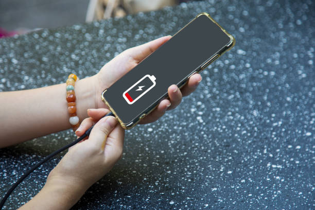 istock Close up a woman hands charging her mobile phone with charging icon 1442169456