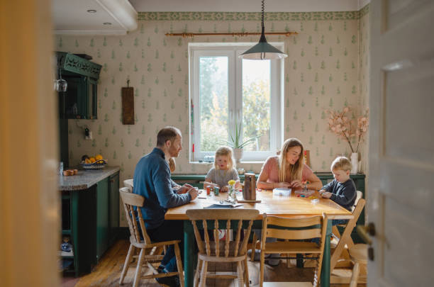 istock Happy young family at dining table at home together 1442169702