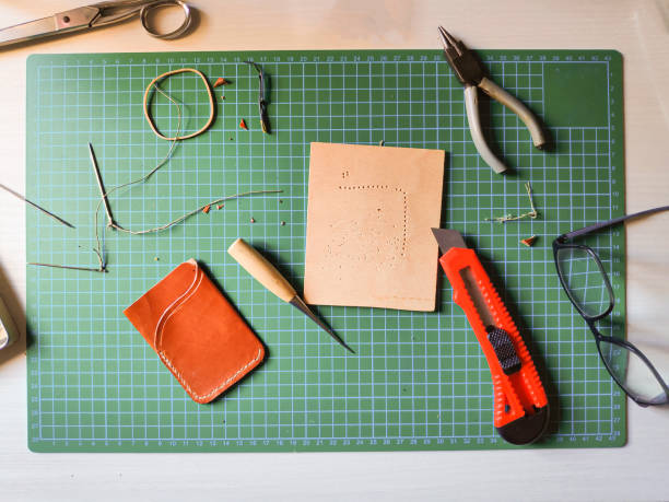 istock leather craft tools on wooden background. flat lay 1442169713