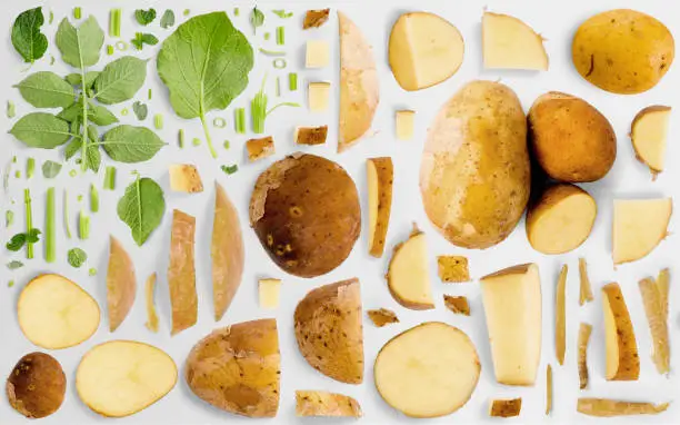 Potato vegetable piece, slice and leaf collection. Flat lay, seamless abstract background.