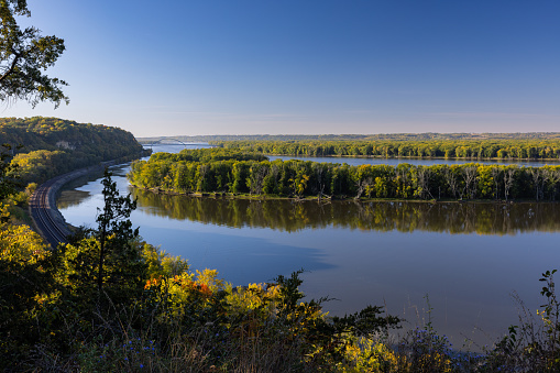 A scenic view of the Mississippi River with railroad tracks during autumn.