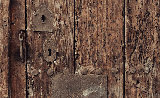 Padlock on an old metal door
