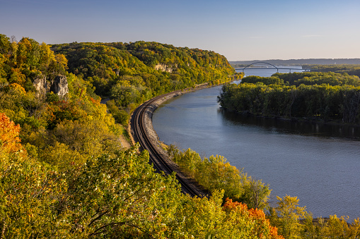 A scenic view of the Mississippi River with railroad tracks during autumn.