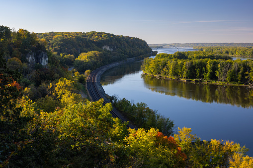 A scenic view of the Mississippi River with railroad tracks during autumn.