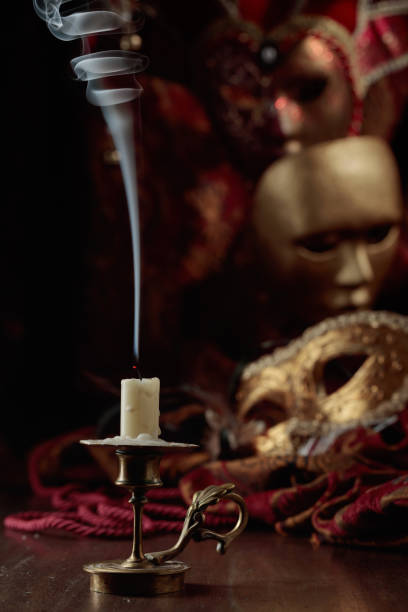 istock Still life with an extinguished candle and carnival masks. 1442174004