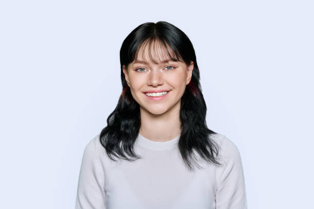 istock Smiling young female looking at camera on light background 1442181569
