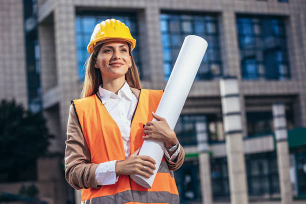 istock Engineer woman in safety equipment  holding plans. Building, developing, construction and architecture concept. 1442181724