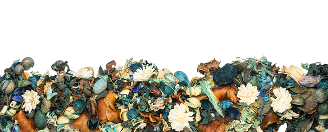 Colorful potpourri of deco material with flowers as border, banner or panorama on white background