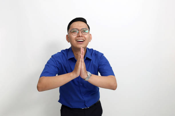 istock Young asian employee holding hands in apologize and need help gesture. Isolated on white background with copyspace 1442185521