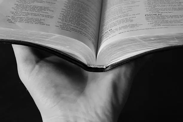 Photo of Hand holding Bible open