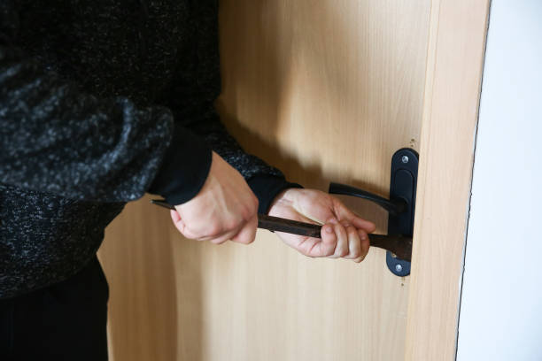 istock Criminal with crowbar near the doors. Robber breaking into house. 1442186679