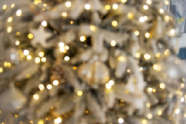 Defocused Texture background for advertising, space for text. Toys, garlands, balls with feathers, deer hang on artificial, snow-covered Christmas tree. New Year greeting card. Festive decoration