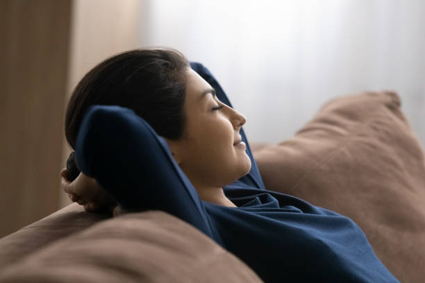 istock Calm Indian woman relax on sofa sleeping 1442186894