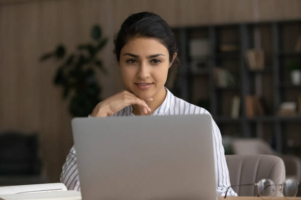 istock Young Indian woman work on laptop at home office 1442186950