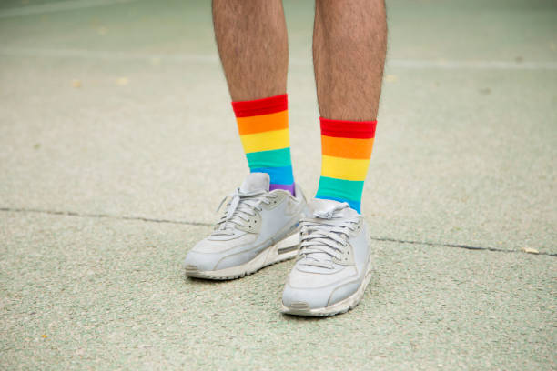 istock Feet with trainers and rainbow socks 1442187892