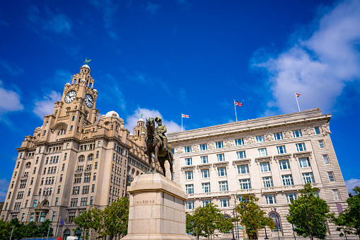 Liverpool Pier head Edward Vll Statue with Royal Liver building and Cunard buildingin England UK United Kingdom