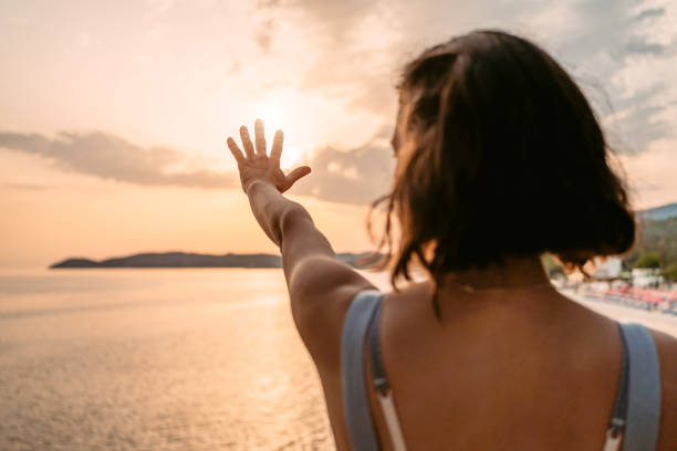istock Young Woman Blocking The Sun With Her Hand On The Beach 1442190441