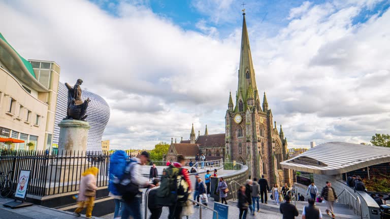 Time lapse of Birmingham St Martin church and Bull Ring Shopping Centre with crowd people and tourist walking in the city of Birmingham, West Midlands, England