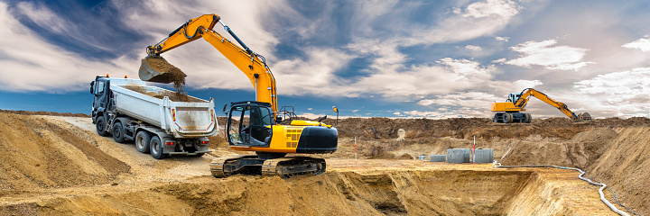 excavator is digging and loading at construction site