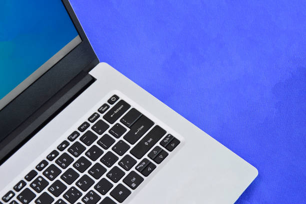 istock top right view of a white laptop on a blue background 1442194764
