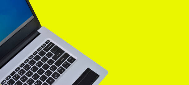 istock top right view of white laptop on yellow background 1442194769