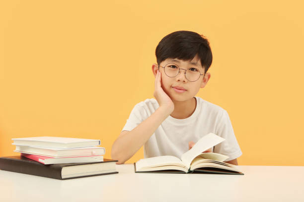 istock A young student studying with his hand on his chin and an open book 1442195007