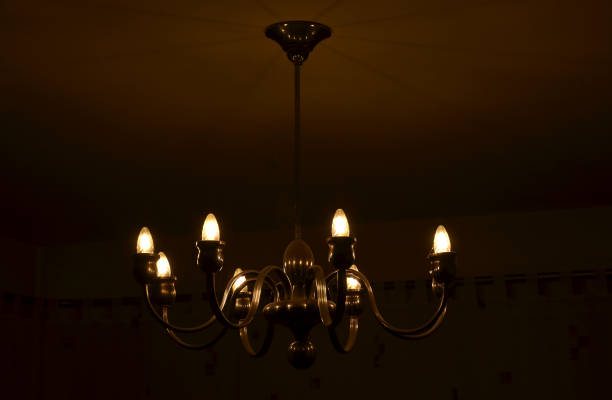 istock old historical eight-armed chandelier. silver single with spruce cone shaped bulbs and a ball at the bottom. white room with curtain. bottom view. candlestick shape, spider 1442195734