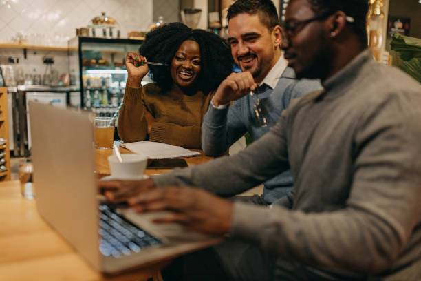 istock Happy college friends researching something 1442195864